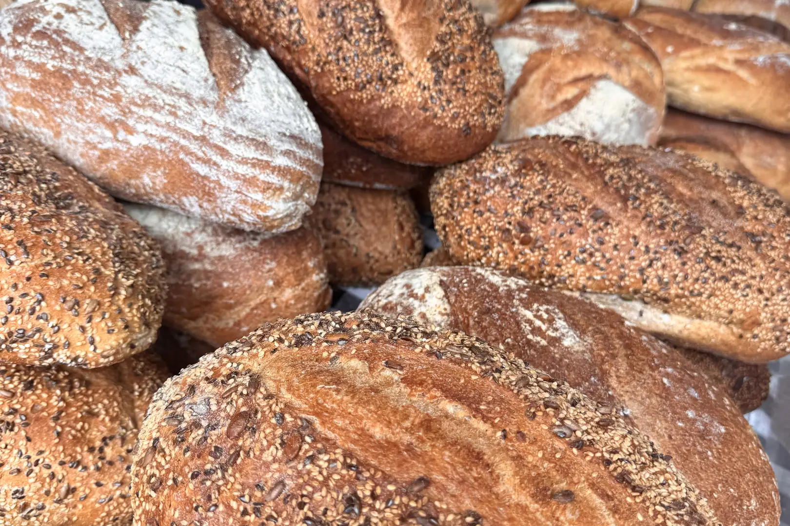 Freshly baked artisan sourdough loaves on a market bakery stall in Beccles