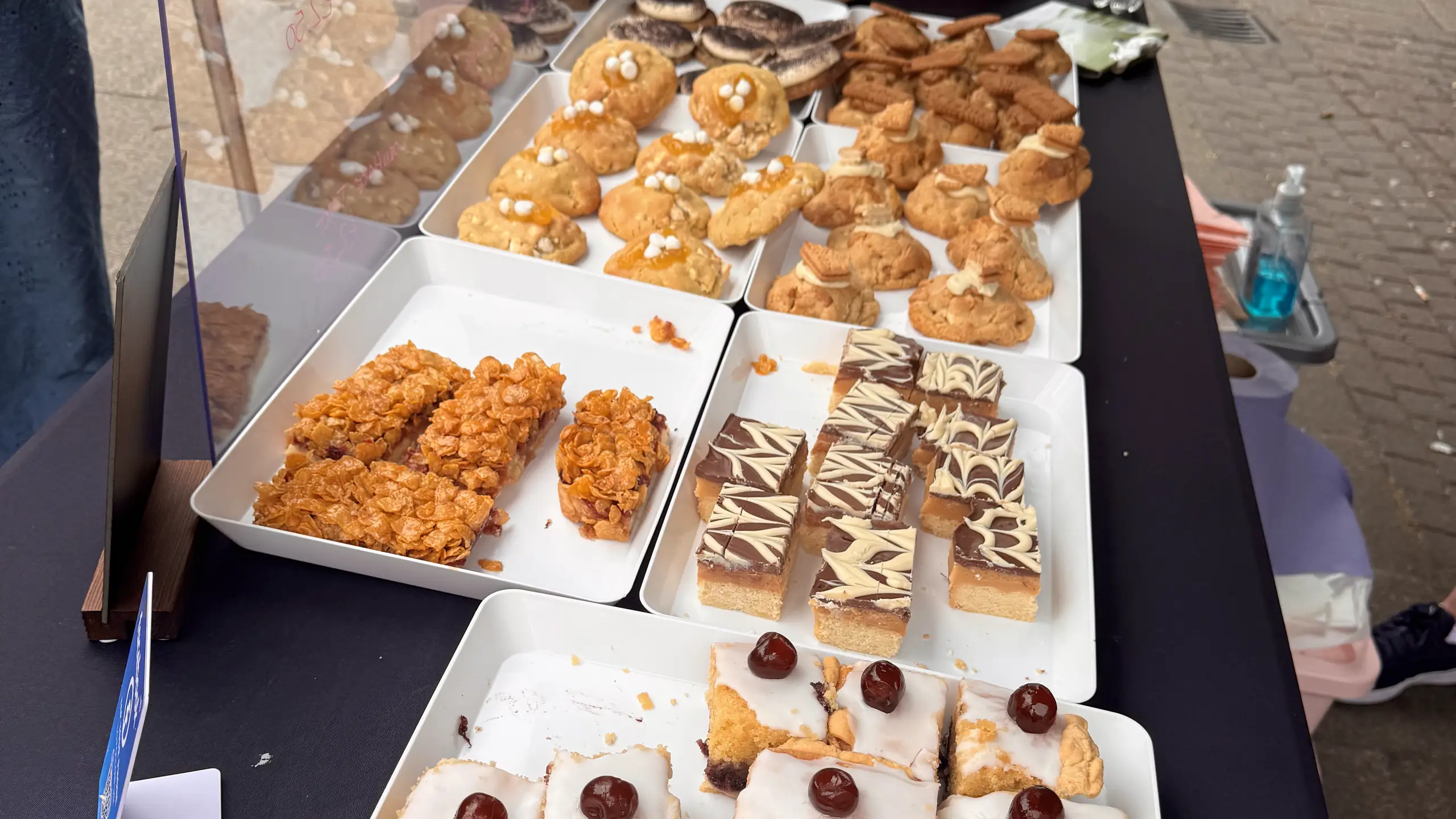 Trays of flapjacks and iced slices on a cake stall at Beccles Sunday Market