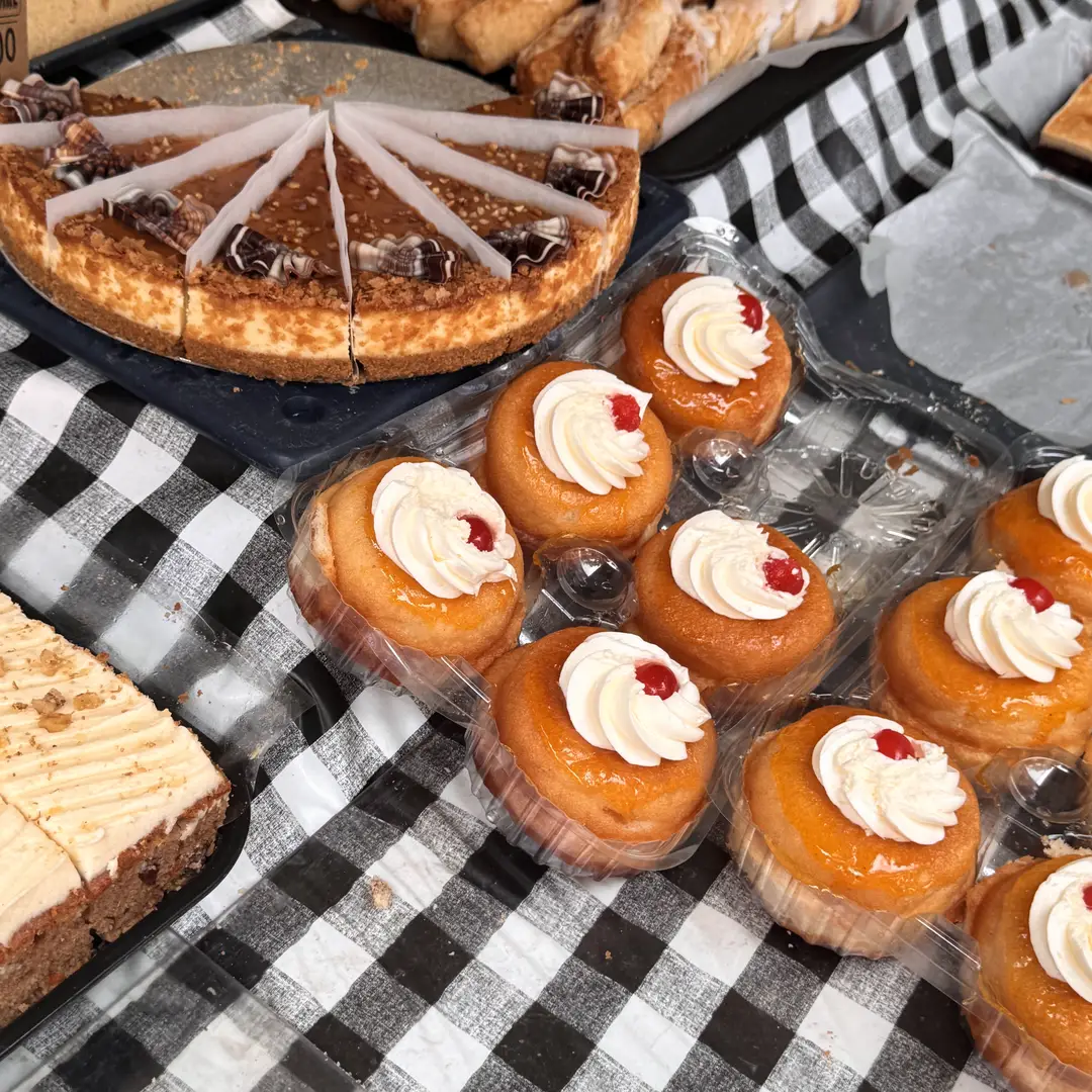 Cream-topped tarts on a market bakery stall