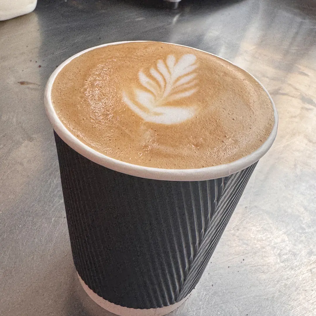 A takeaway flat white with leaf latte art at Beccles Sunday Market