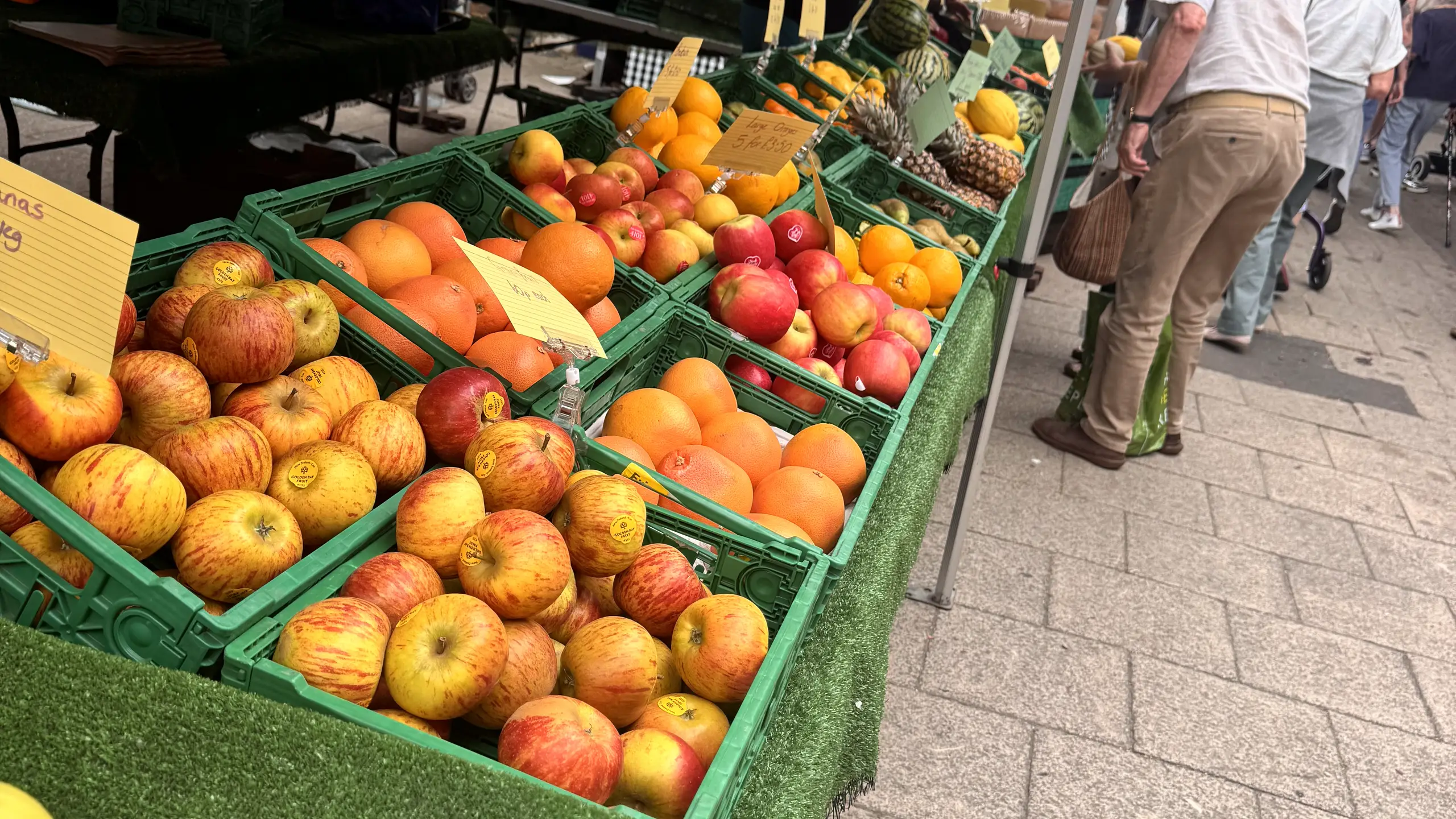 Crates of apples and oranges on a fresh produce stall at Beccles Sunday Market