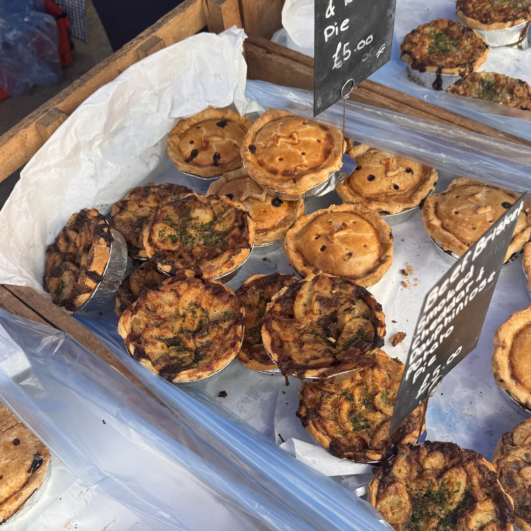 Trays of savoury pies and tarts on a hot food stall at Beccles Sunday Market