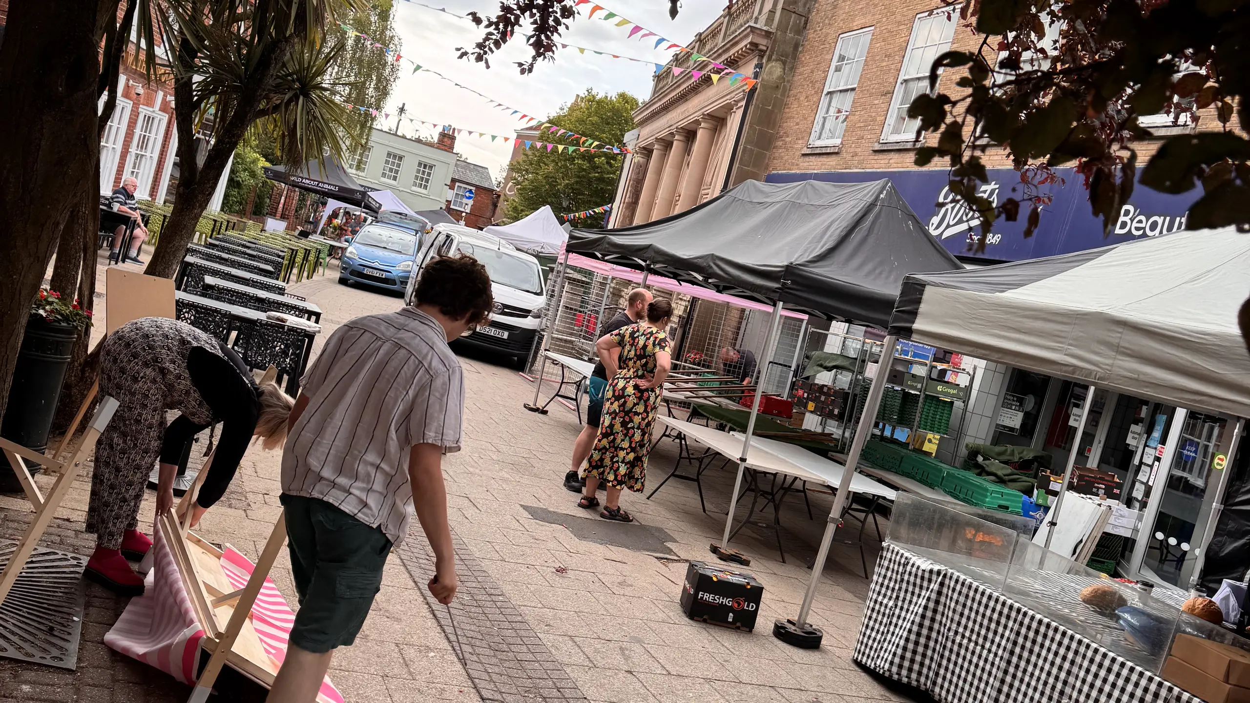 Market stalls and shoppers along the street at Beccles Sunday Market