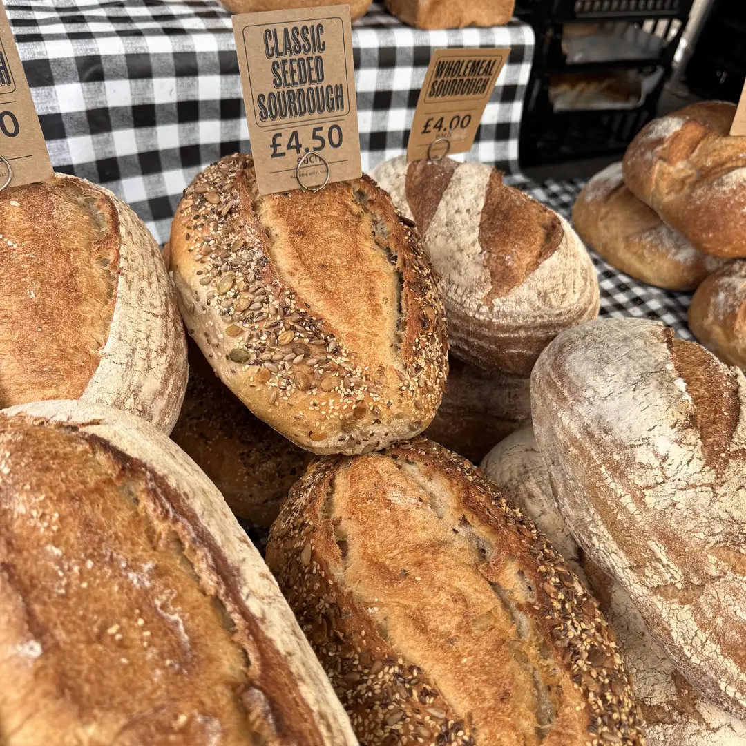 Seeded sourdough loaves on a market bakery stall